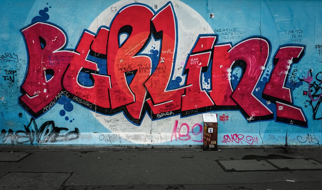 red-berlini-word-painted-on-wall-with-blue-background-2bsd55ynno4